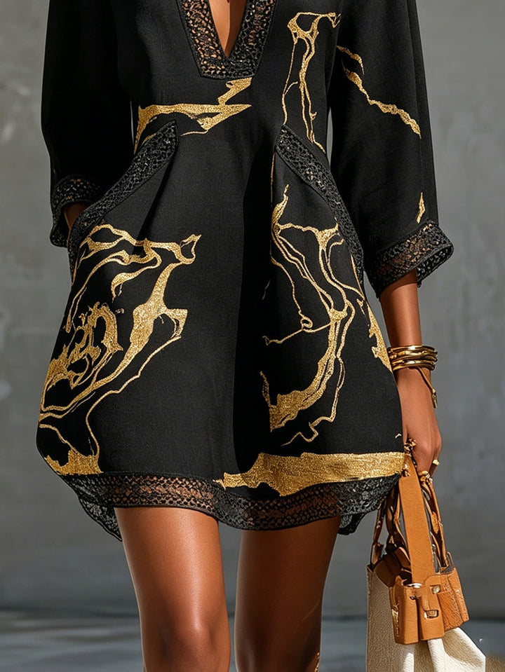 Donatella | Mini dress in black with golden marble print